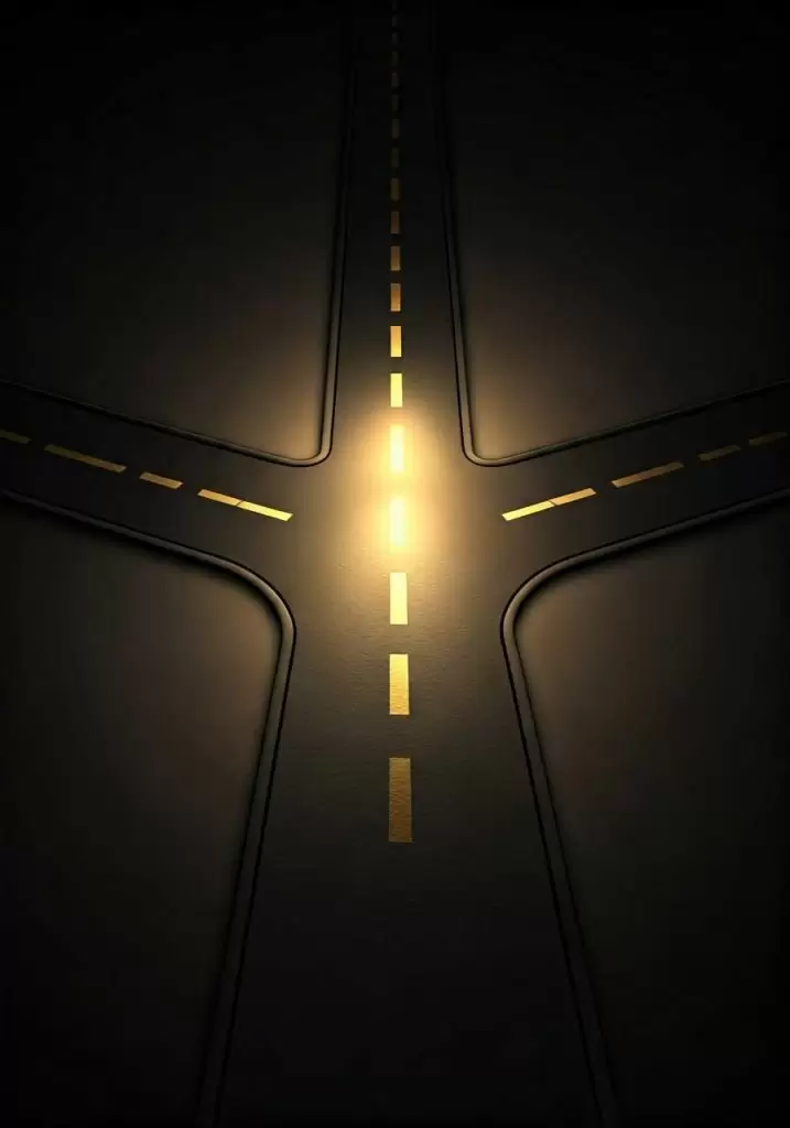 A high-angle aerial view of a multi-road intersection, depicting complex traffic patterns and urban infrastructure. Multiple lanes curve and converge, with visible street markings guiding the flow of vehicles. The scene represents decision-making, navigation, and movement—fitting the theme of the My NAMS AI Freedom System, which helps online entrepreneurs find the right direction in business.